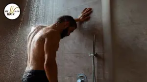 man standing in shower, worried about hair loss