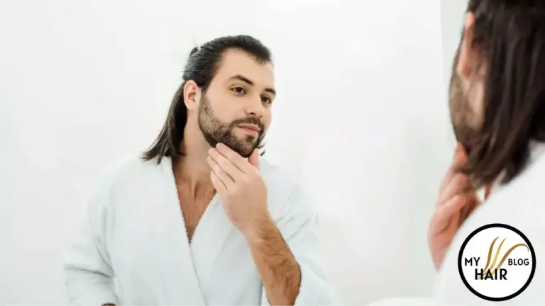 man seeing his beared in mirror